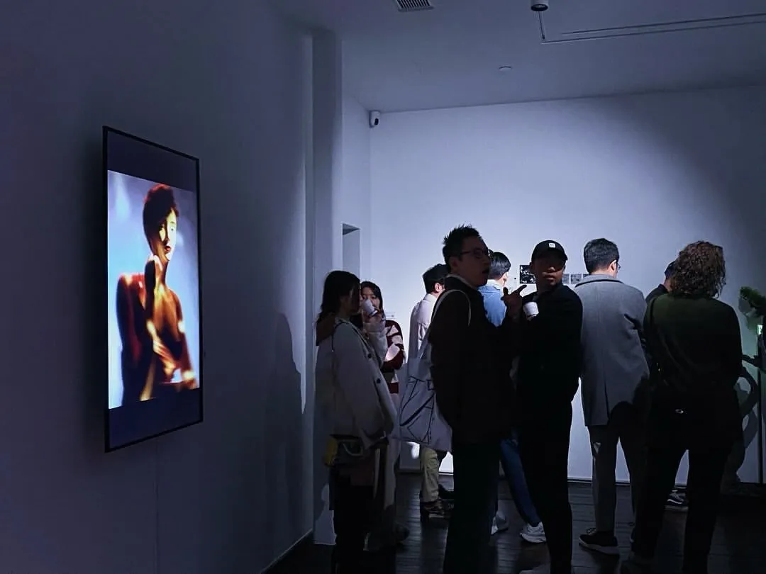 Exhibition view of Shavonne Wong's work at Ora-Ora Gallery during Digital Art Fair, a portrait video installation with visitors in the gallery.