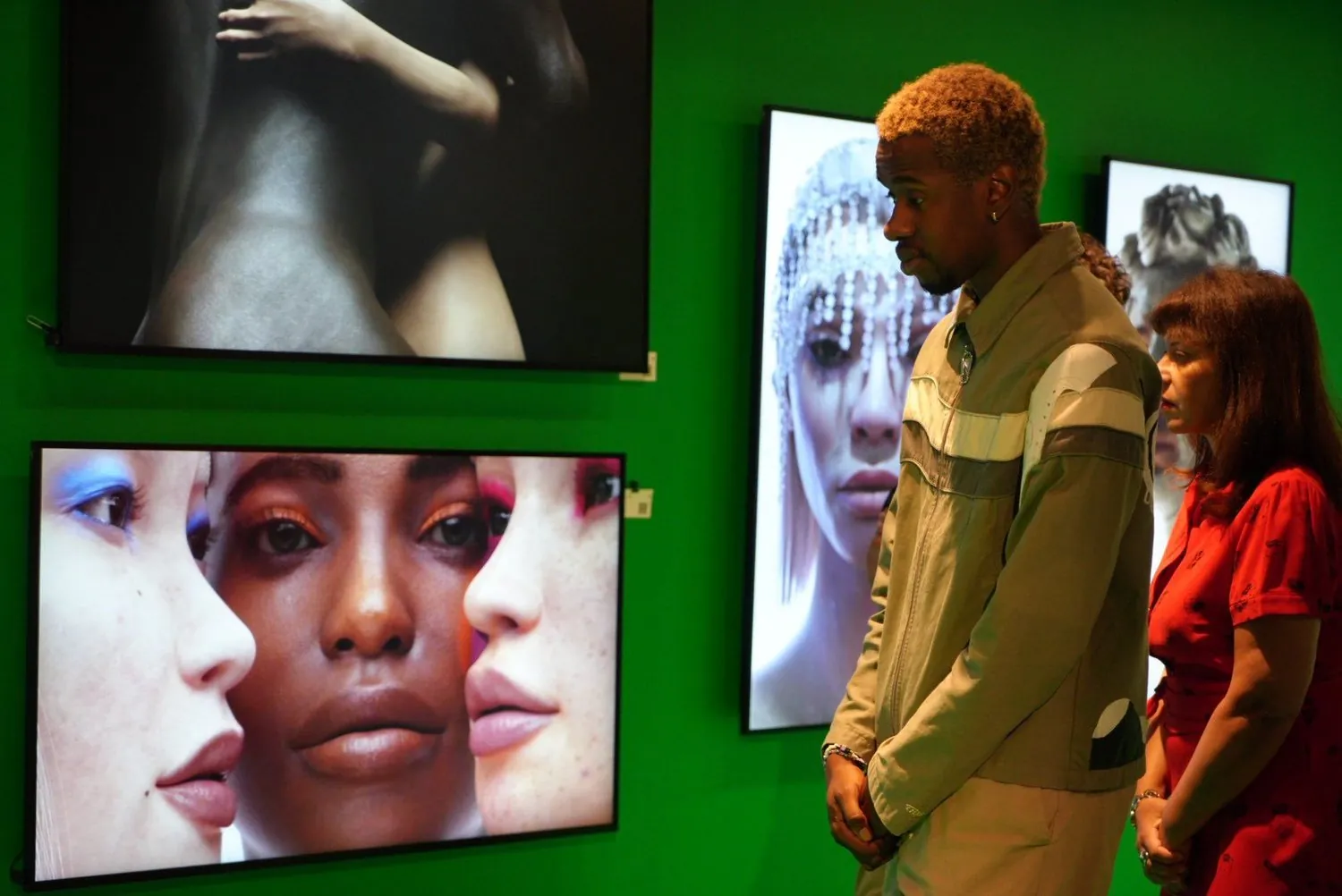 Visitors viewing Shavonne Wong's digital portraits at her NFT Factory solo exhibition in Paris.
