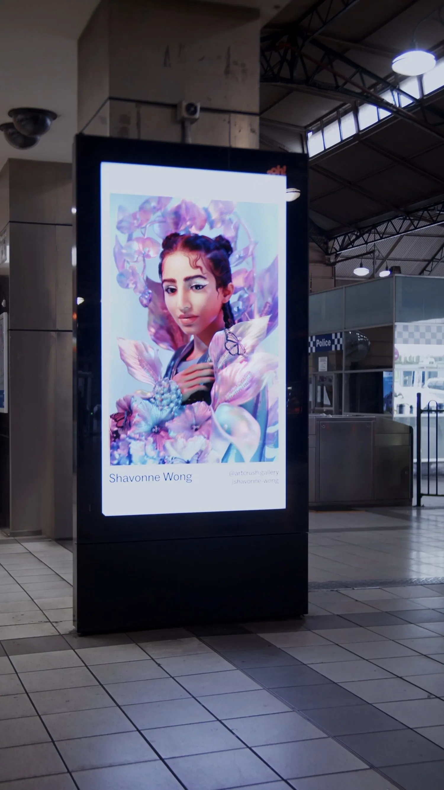 Shavonne Wong's digital portrait displayed on a vertical outdoor screen.
