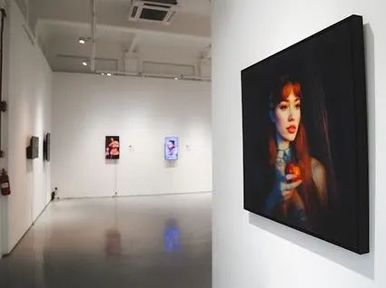 Installation view of EVA at The Columns Gallery, Singapore, featuring lenticular and digital portrait works.