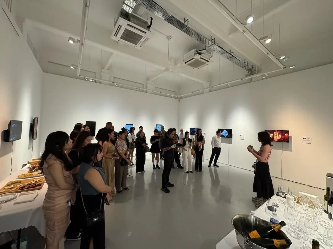 Shavonne Wong giving an artist talk at her solo exhibition EVA at The Columns Gallery, Singapore, visitors engaging with digital and interactive works.