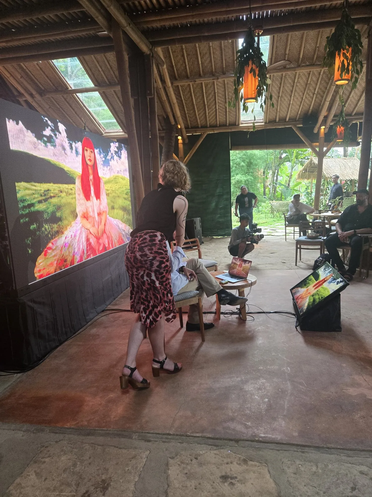 Interactive setup of Meet Eva Here at Silk Art House in Bali, a large screen displaying Eva in a tropical open-air pavilion.