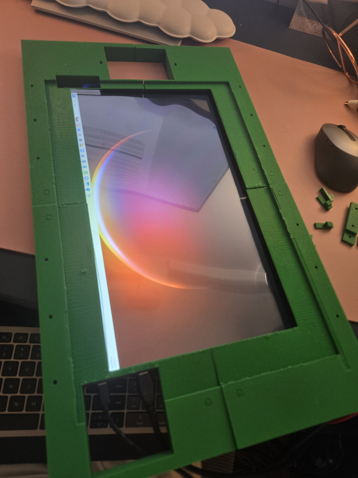 Green 3D printed frame for The Mirror fitted around a screen